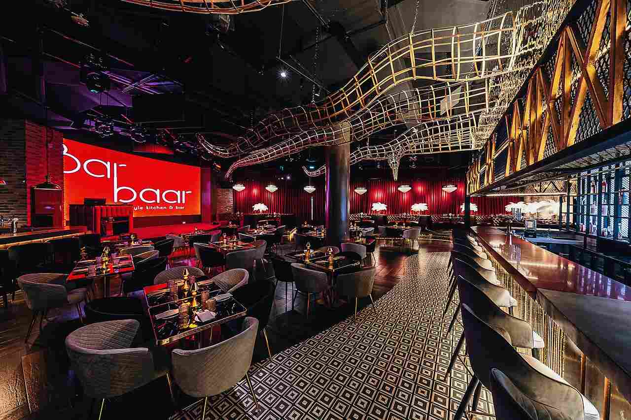 Modern bar setup with high tables and chairs